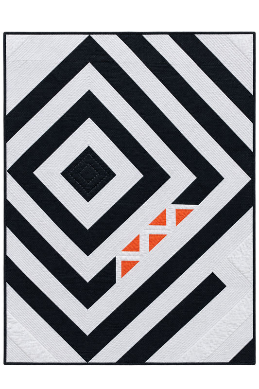 A square quilted rug or textile featuring a bold geometric pattern of black and white concentric diamonds and diagonal stripes, with a small cluster of orange triangles near the lower right area.